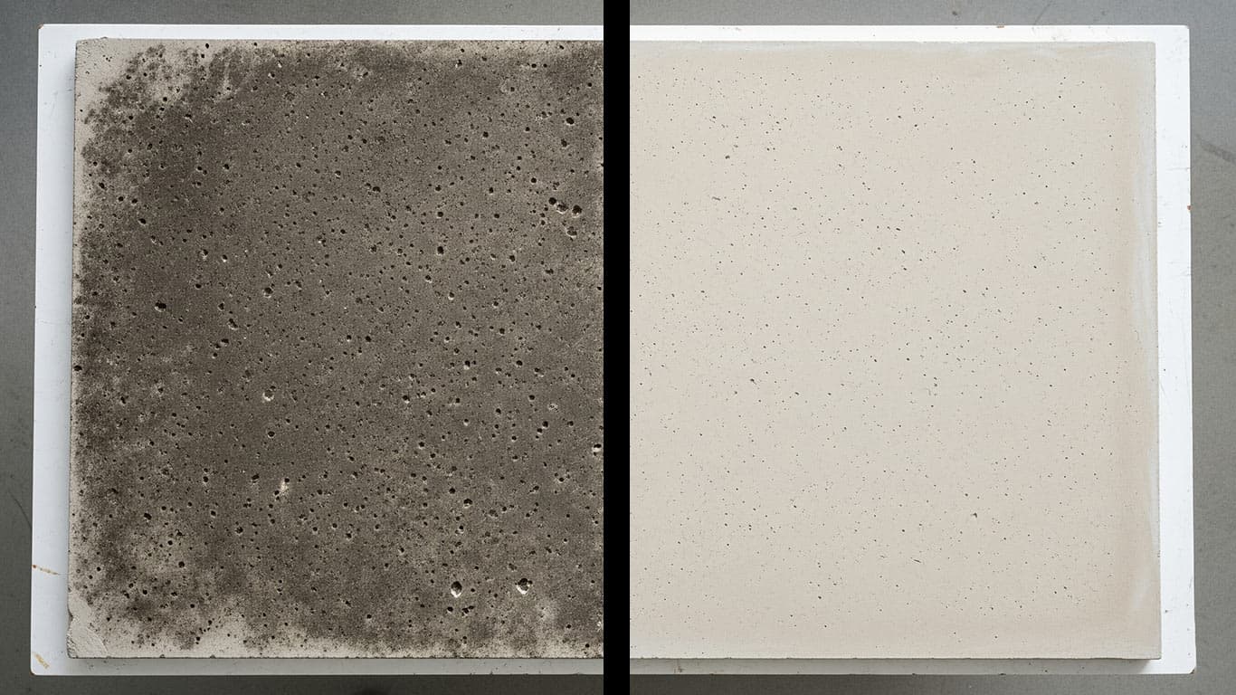 Cement surface undergoing laser cleaning showing precise contamination removal