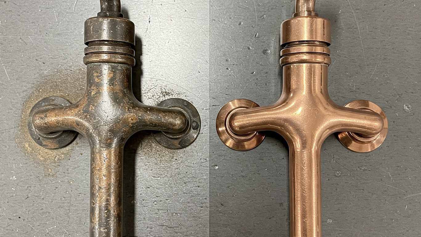 Copper surface undergoing laser cleaning showing precise contamination removal