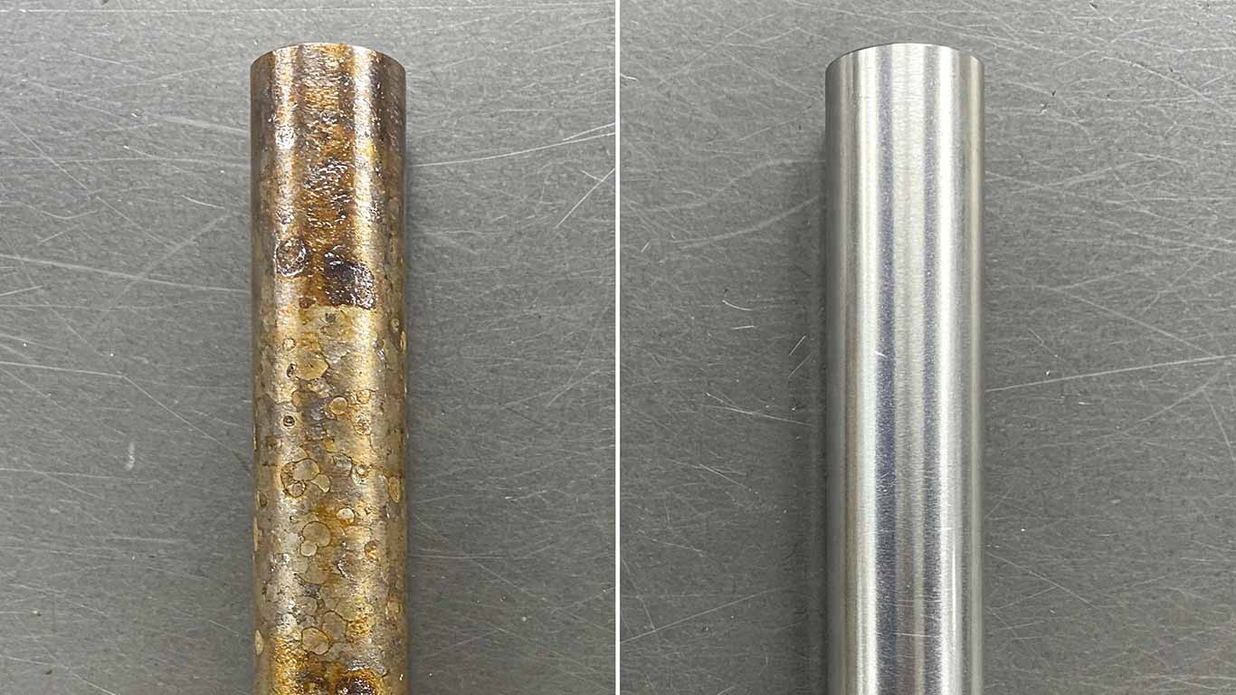 Titanium surface undergoing laser cleaning showing precise contamination removal