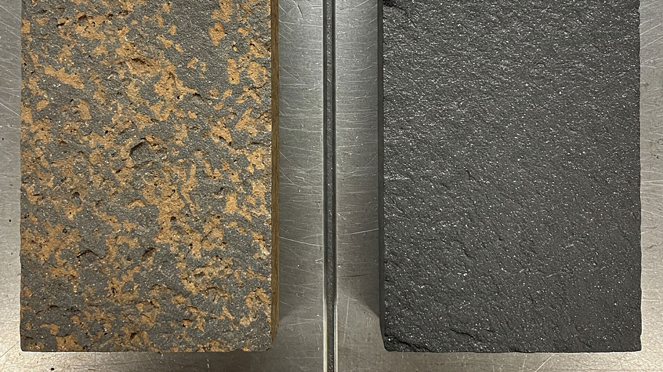 Basalt surface undergoing laser cleaning showing precise contamination removal