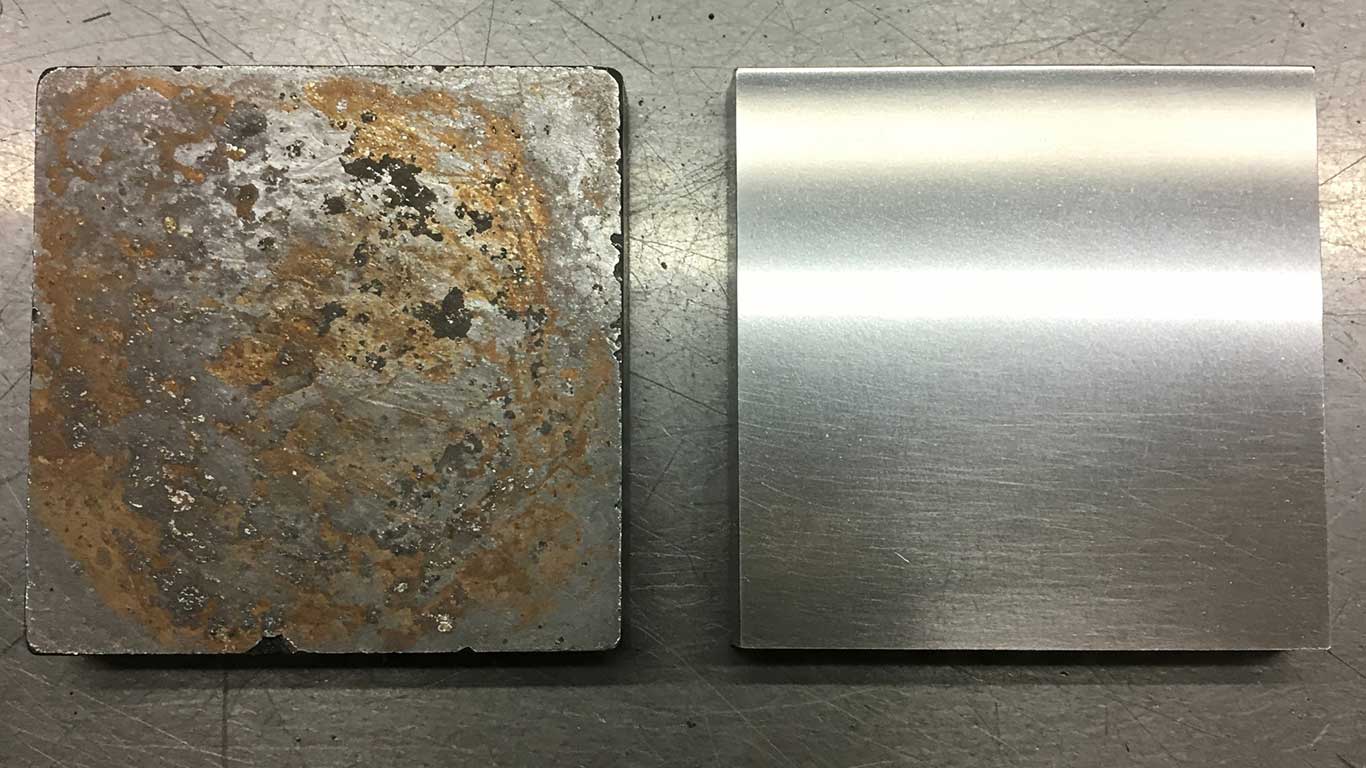 Beryllium surface undergoing laser cleaning showing precise contamination removal