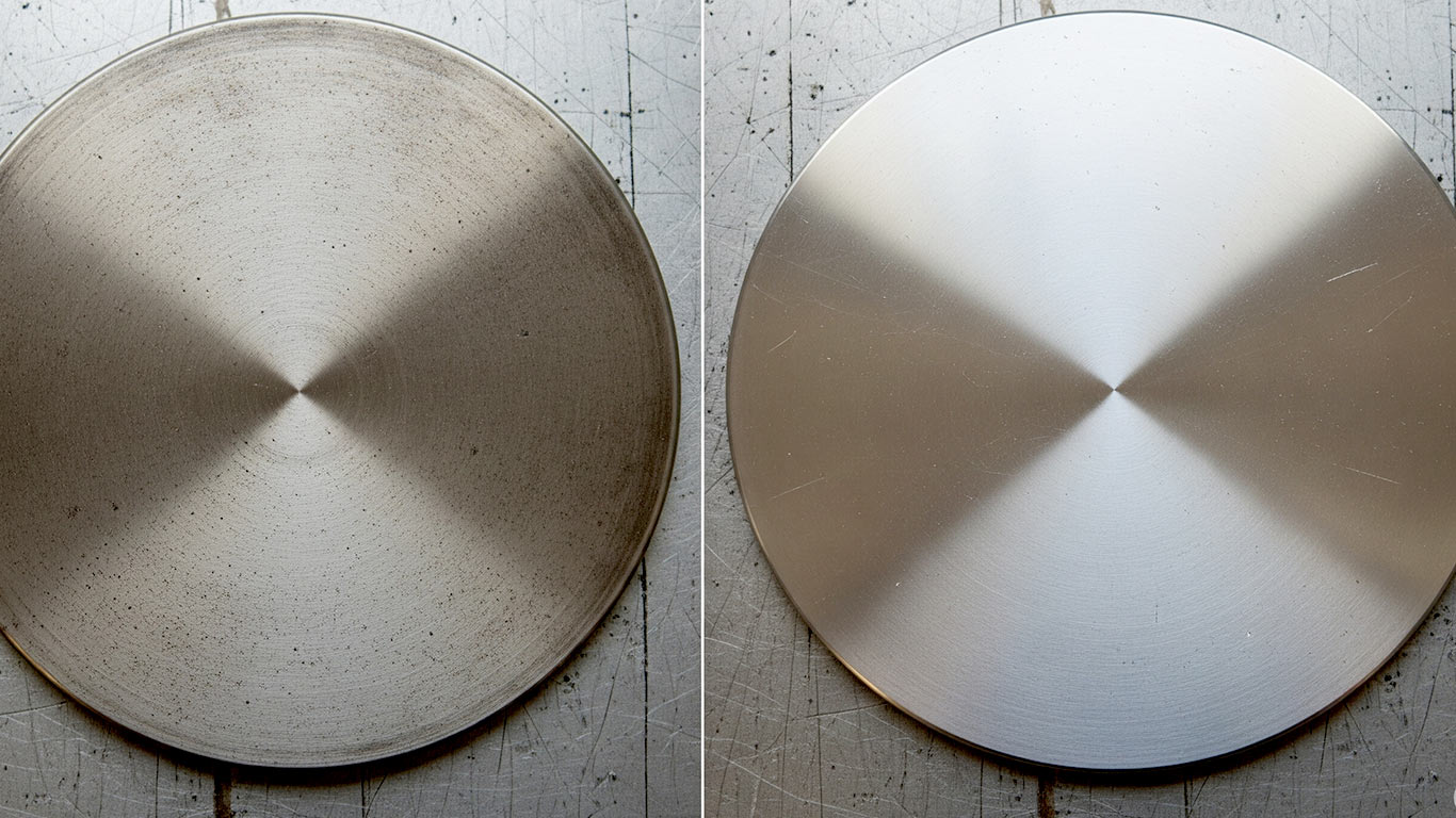 Hafnium surface undergoing laser cleaning showing precise contamination removal