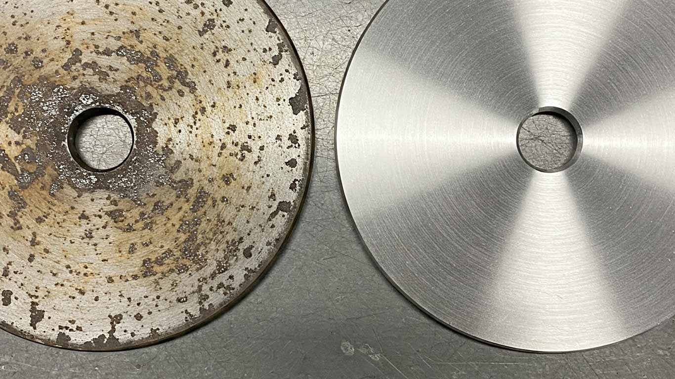 Magnesium surface undergoing laser cleaning showing precise contamination removal