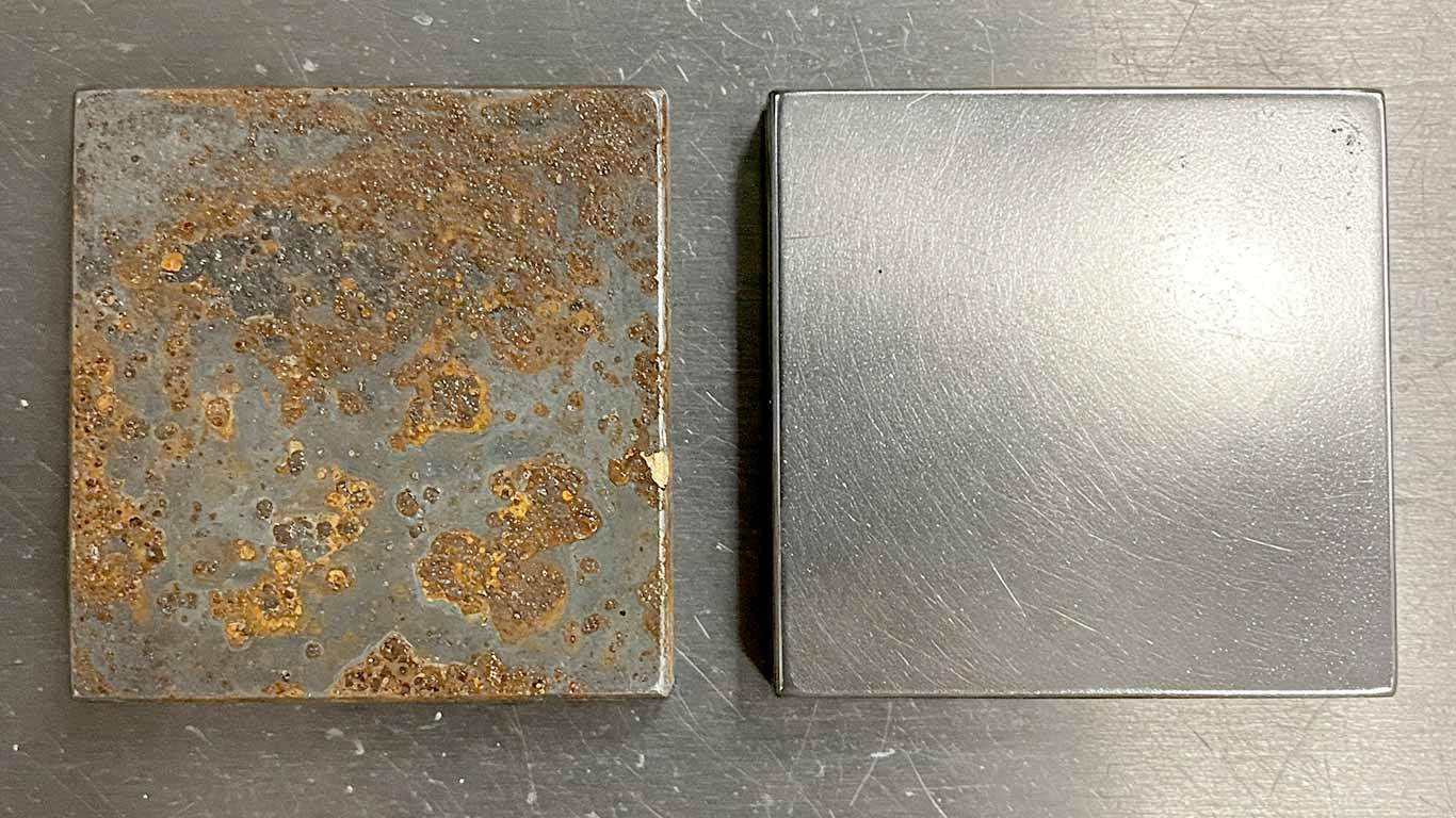 Molybdenum surface undergoing laser cleaning showing precise contamination removal