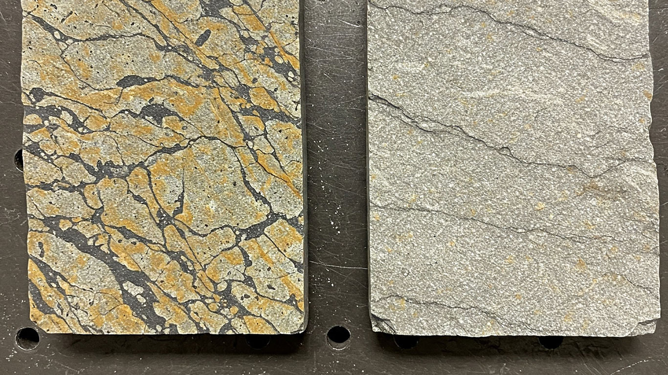 Schist surface undergoing laser cleaning showing precise contamination removal