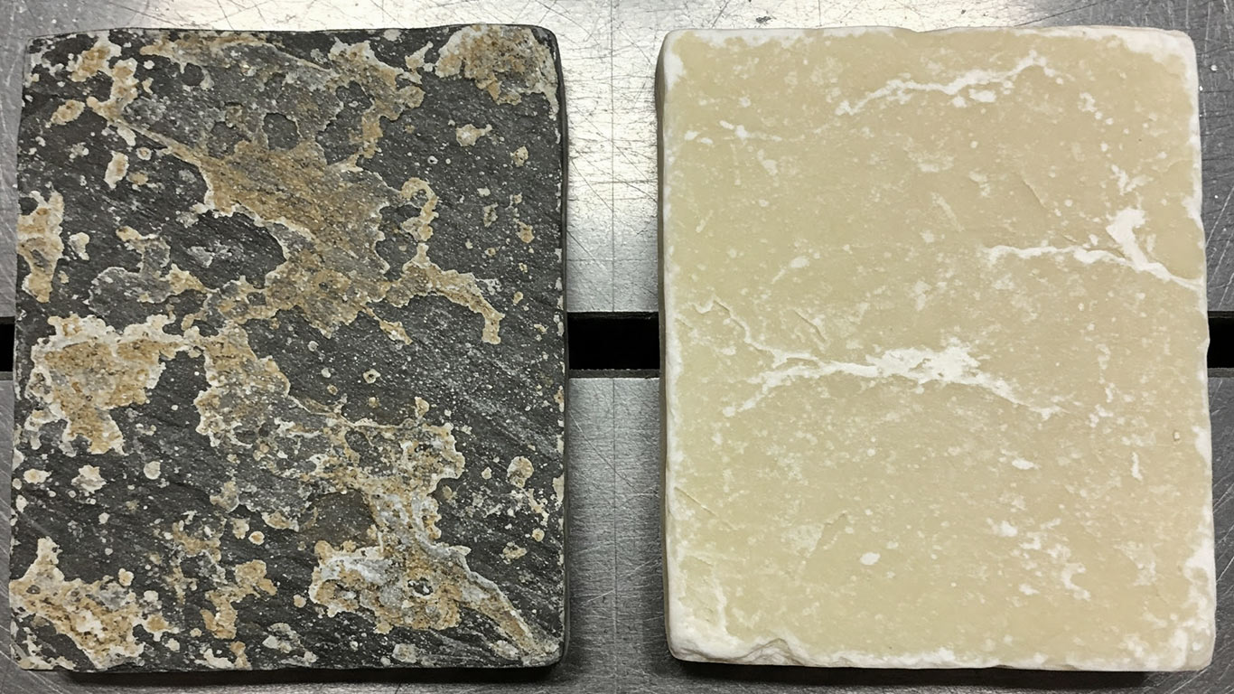 Soapstone surface undergoing laser cleaning showing precise contamination removal